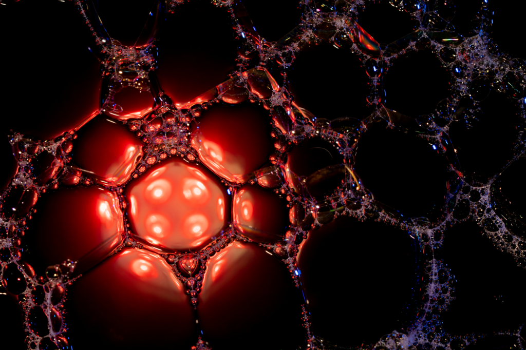 The Art of Drawing Readers In: Your attractive post title goes here Close-up of soapy bubbles with red and black highlights, showcasing a dramatic abstract texture.