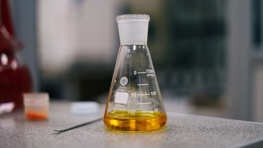 Mastering the First Impression: Your intriguing post title goes here Close-up of an Erlenmeyer flask with yellow liquid in a laboratory setting.